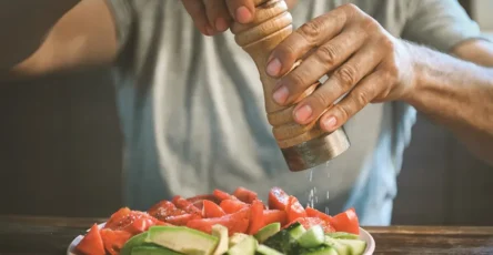 Man eating vegetables fruits salt